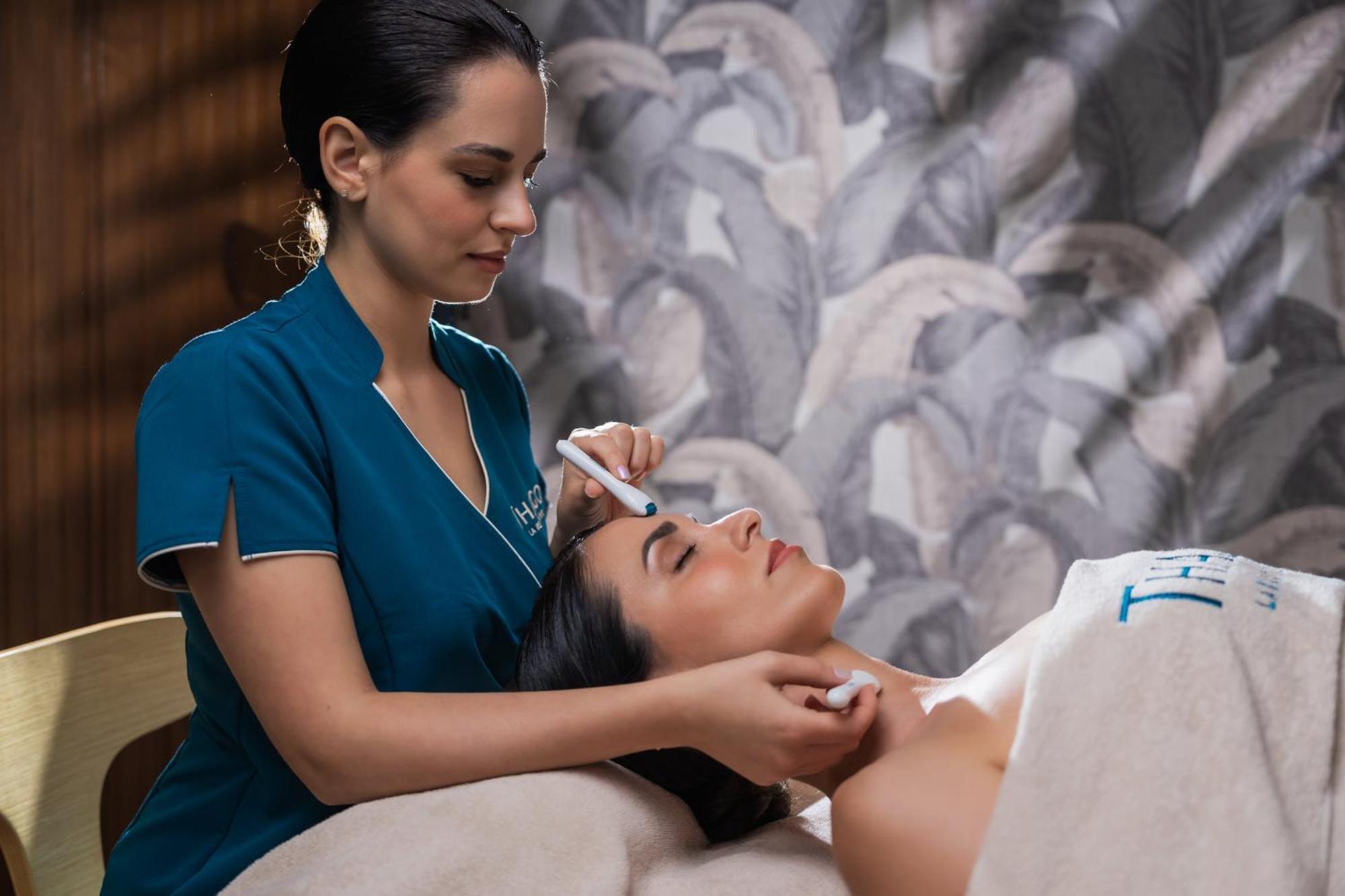 Hilton Rijeka Costabella Beach Resort And Spa Exteriör bild A woman receiving a facial treatment